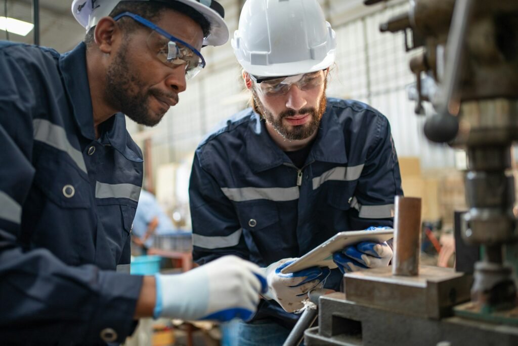 male engineers using tablet view drawing design of workpiece material on drilling machine at factory.jpg